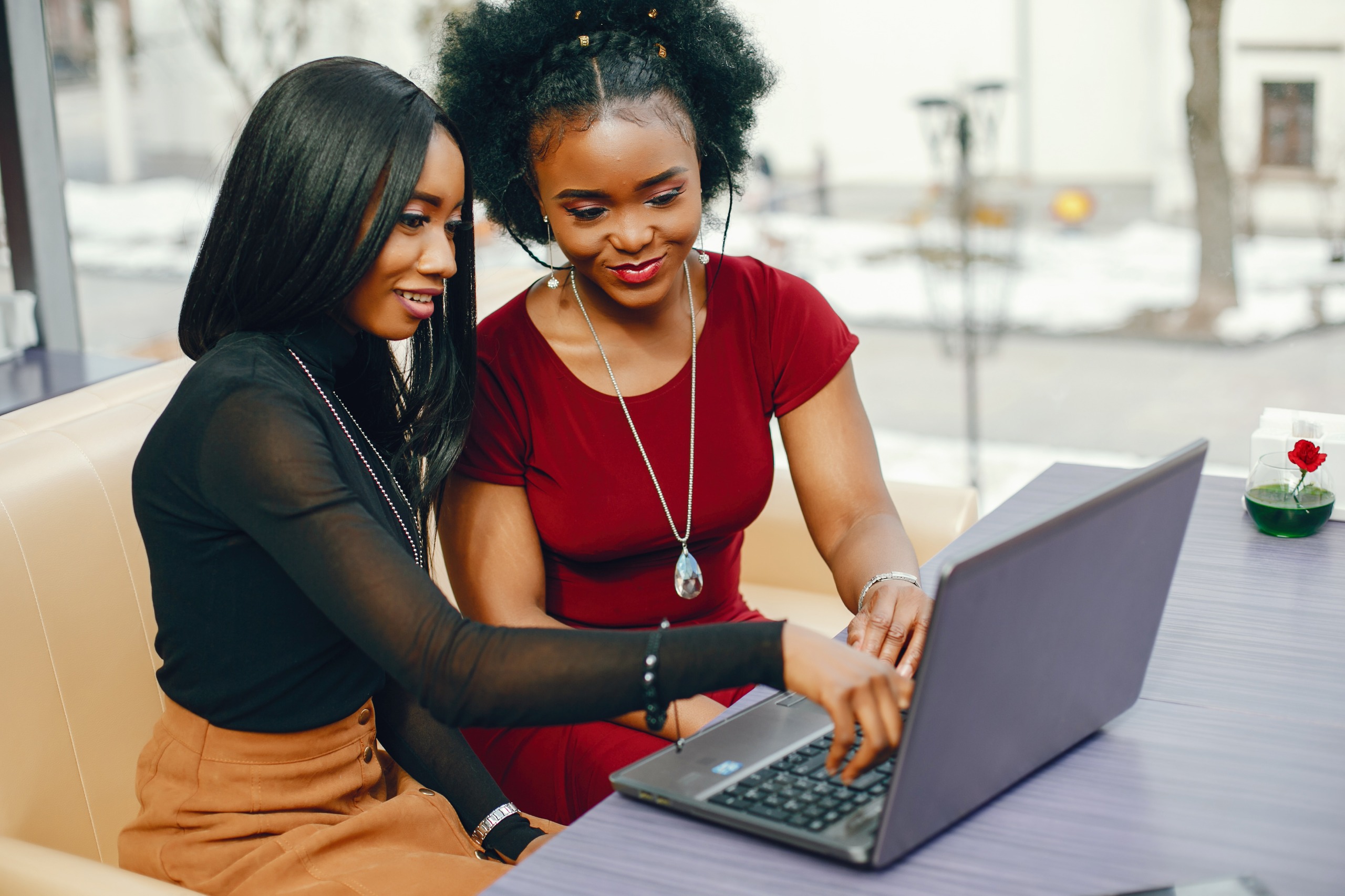 Two women collaborating at a laptop